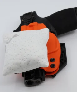 Cloudster Pillow White Deluxe holster wedge in front of an IWB holster