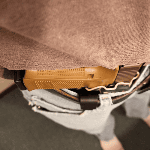 AIWB Positioning Comfort Tips Holster wedge attached to a person’s waist with a Cloudster Pillow.