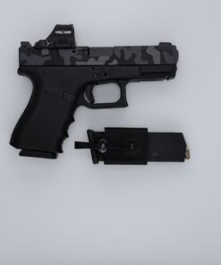Pocket mag carrier shown next to a Glock pistol for spare magazine carry