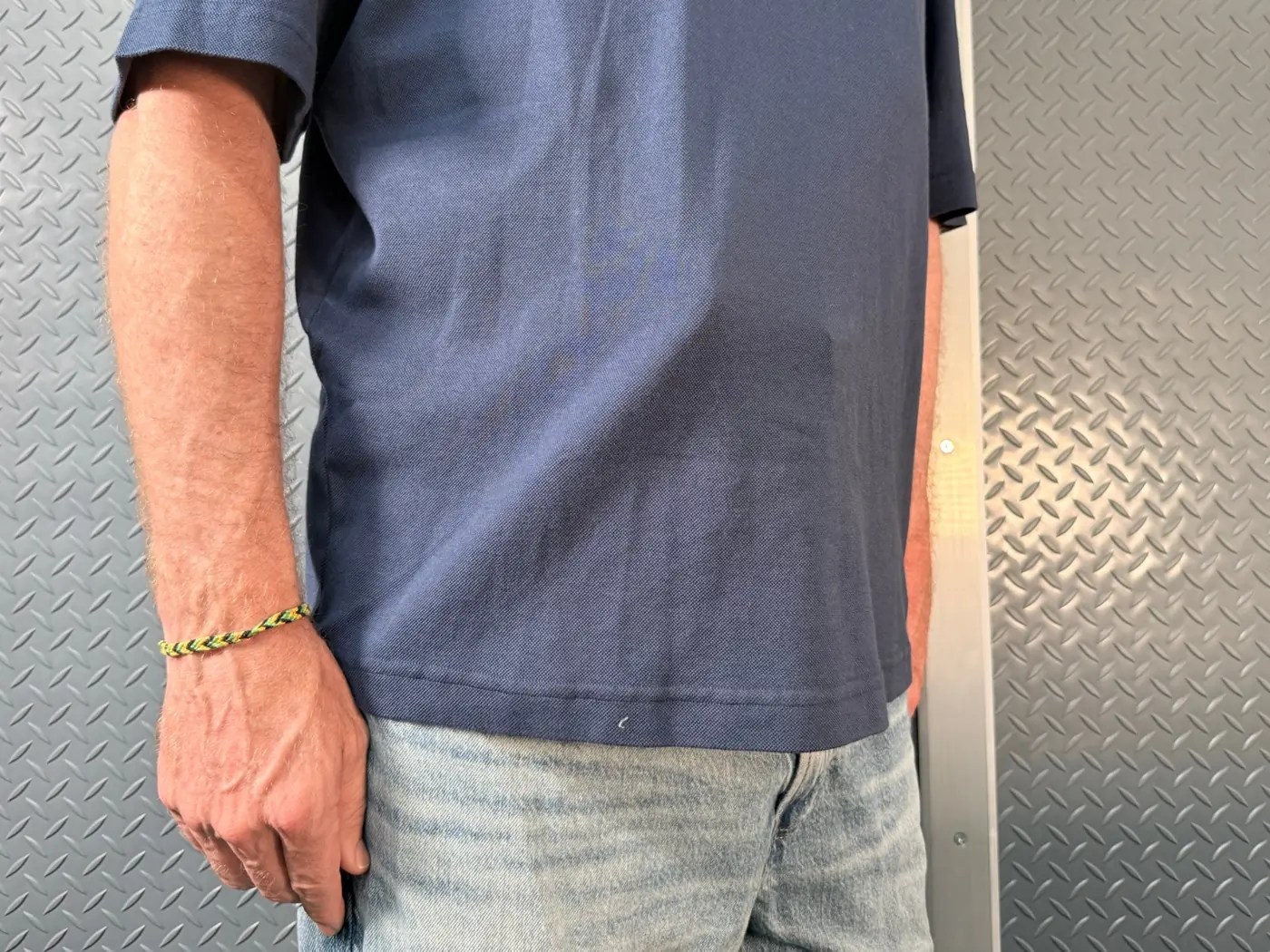 Bellyband holster with a full-size 1911 worn under a polo shirt with the outline showing through