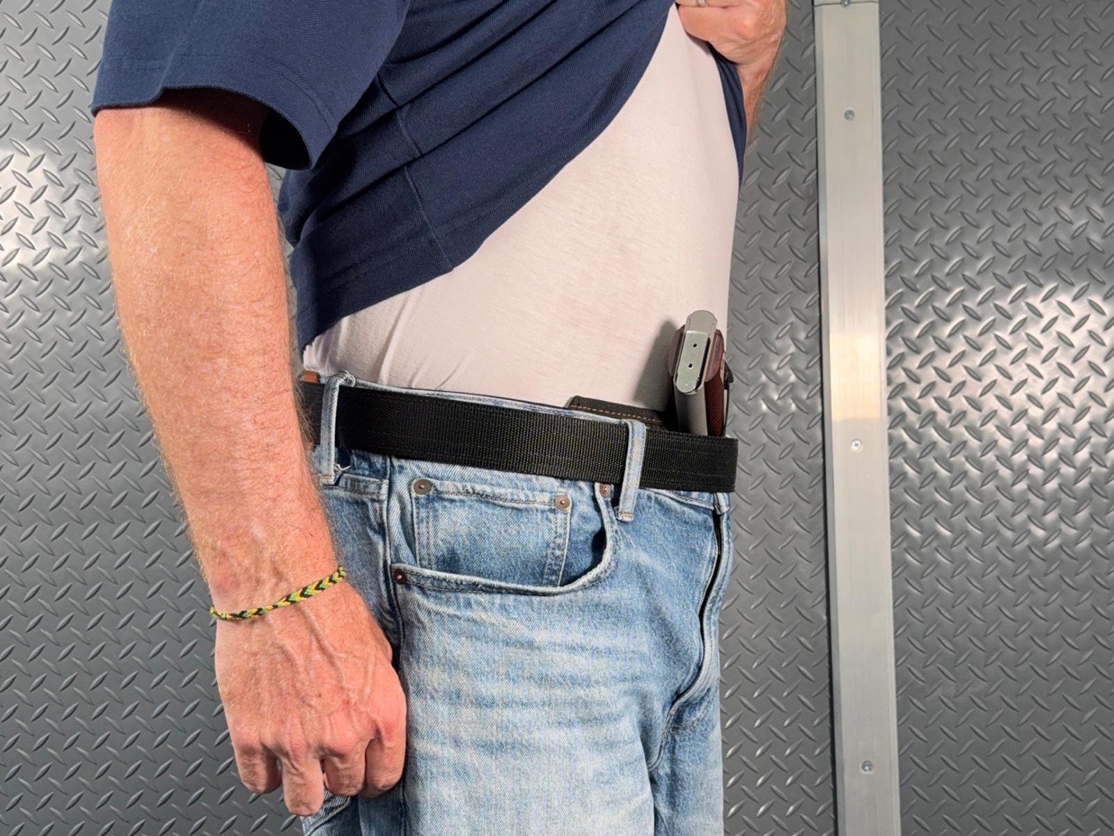 IWB holster with no pillow — the 1911 grip kicks out away from the body and prints.