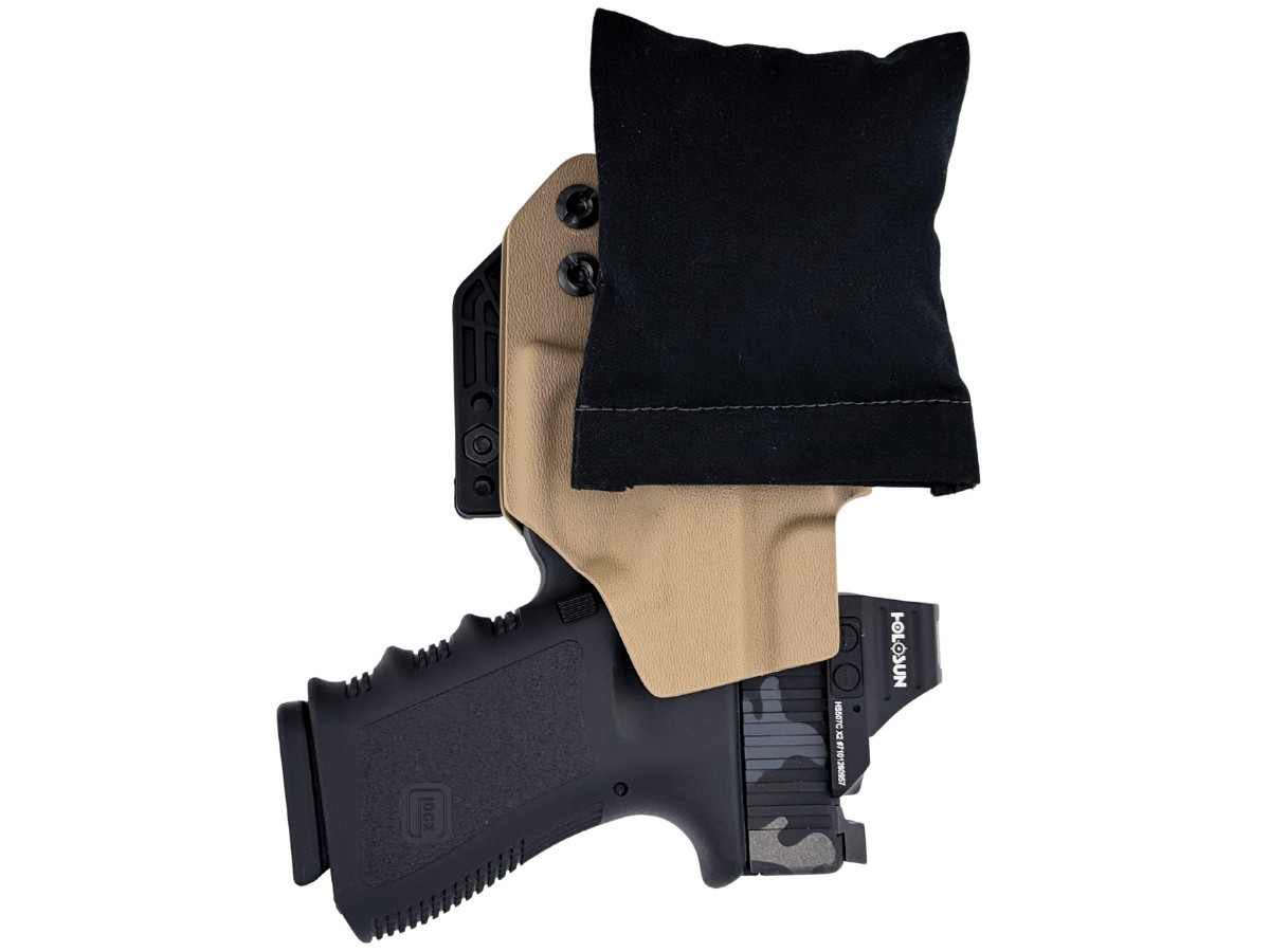 Cloudster Pillow with a coyote-tan FDE kydex holster and a Glock with a Holosun optic