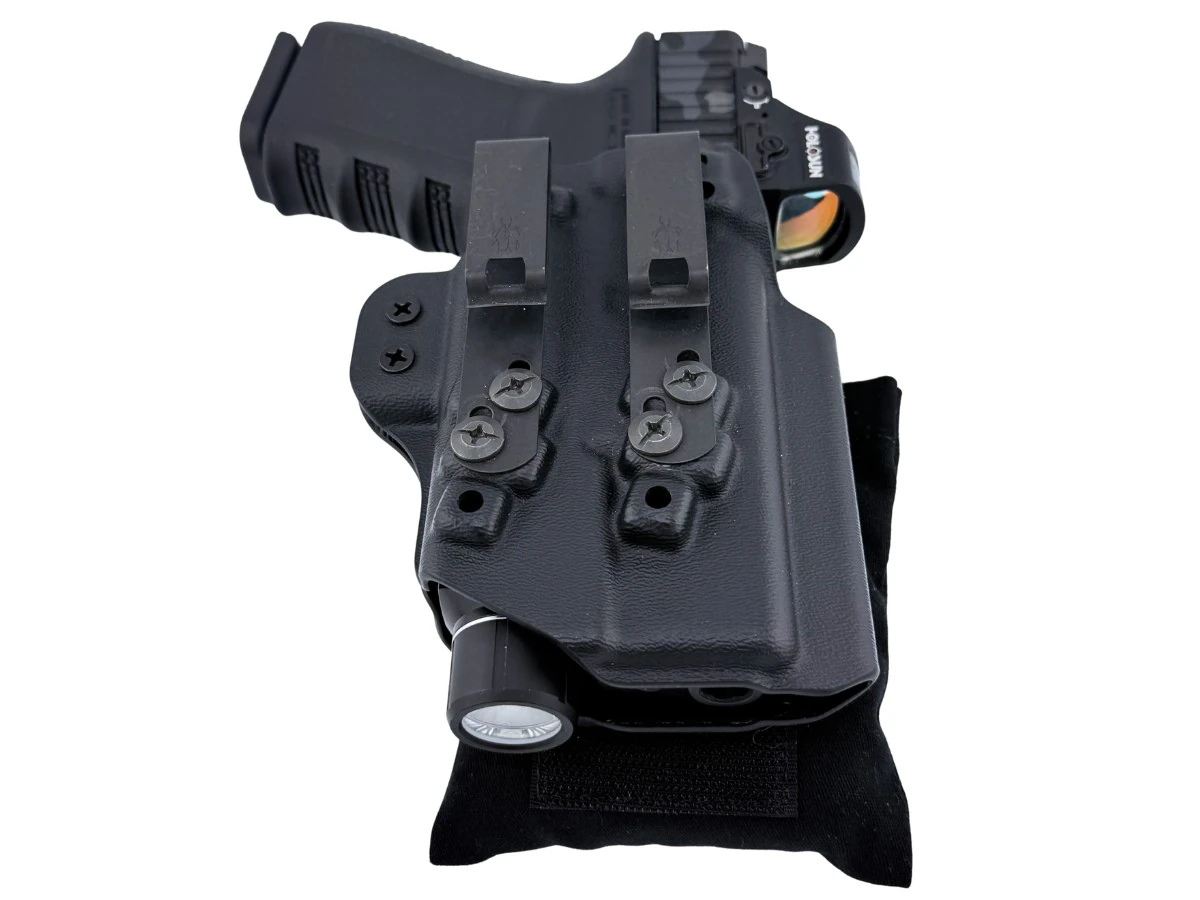 Light-bearing kydex rig with a weapon light and the Cloudster Pillow attached behind