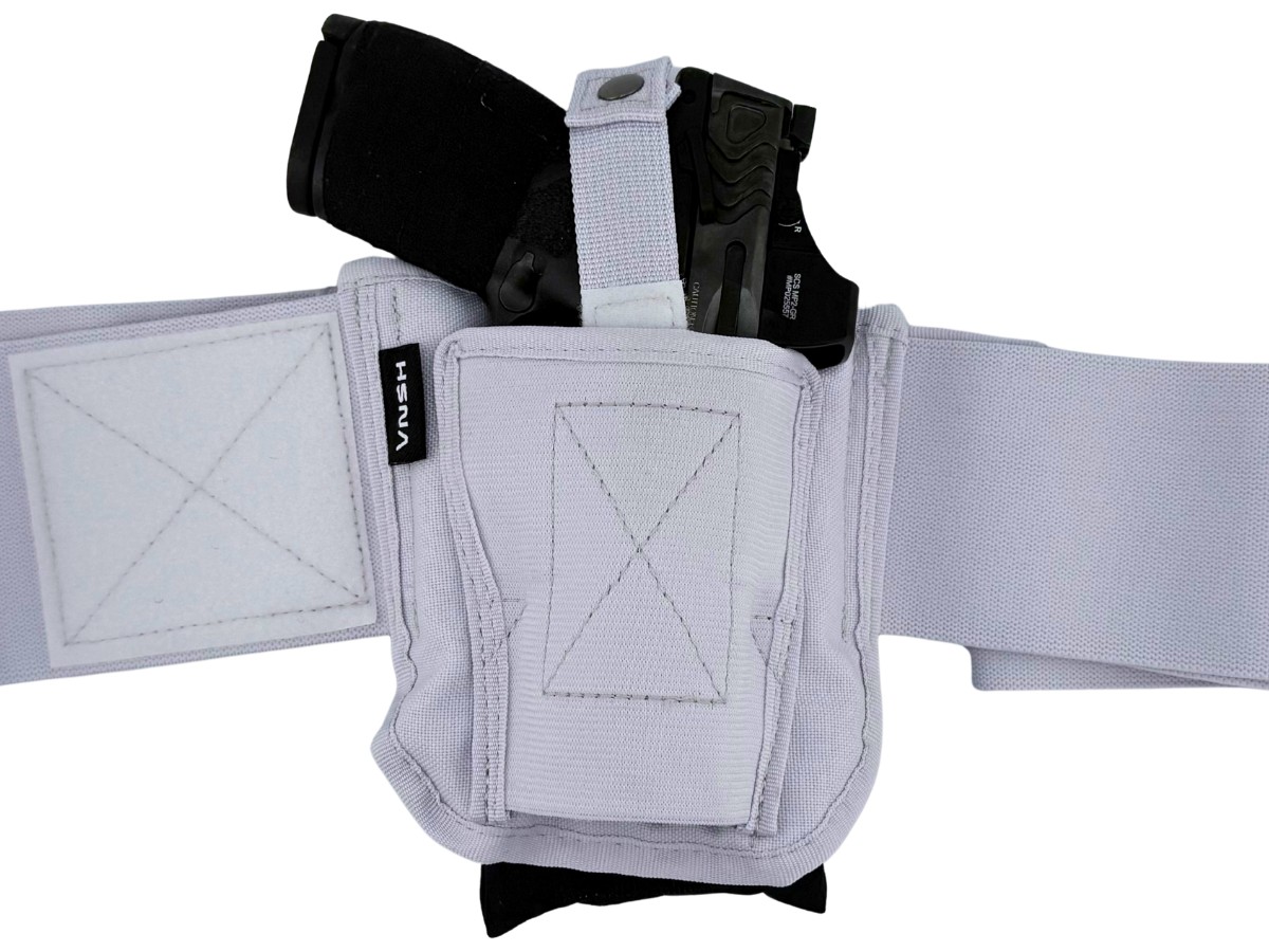 Cloudster Pillow tucked behind a white VNSH holster with a pistol